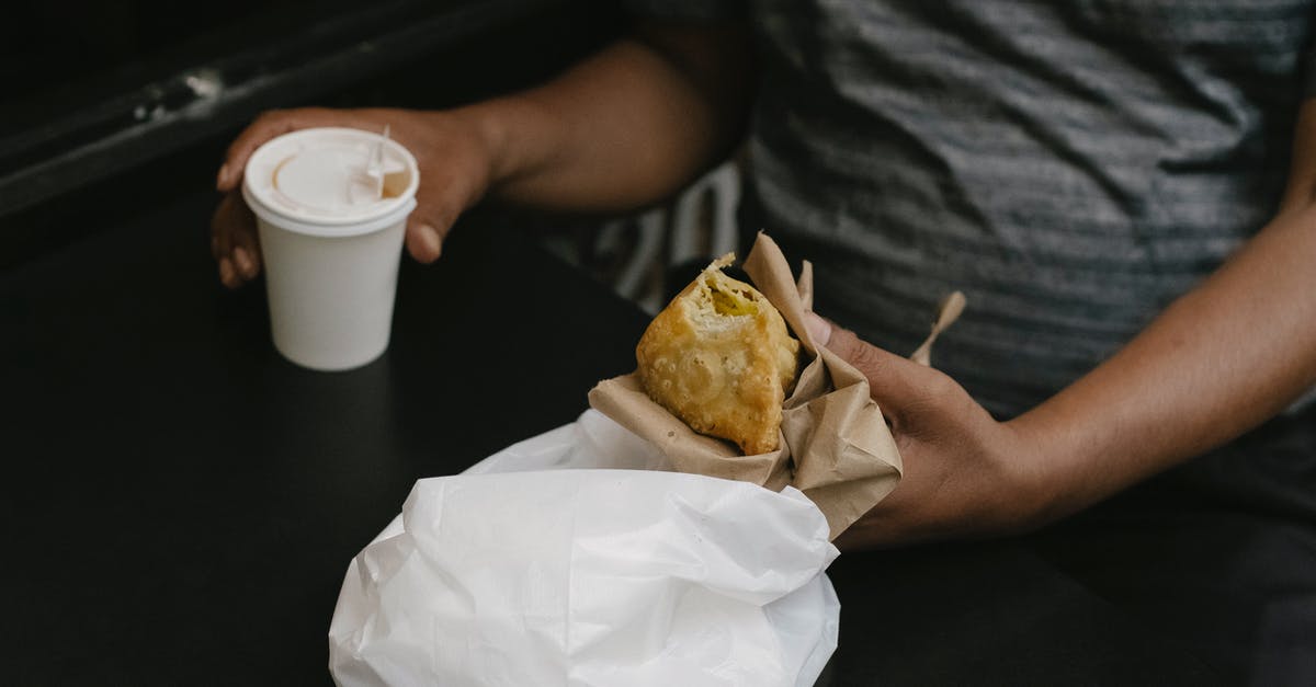 What's common to pie crusts and deep fried battered foods? [closed] - Crop person with cheburek and coffee