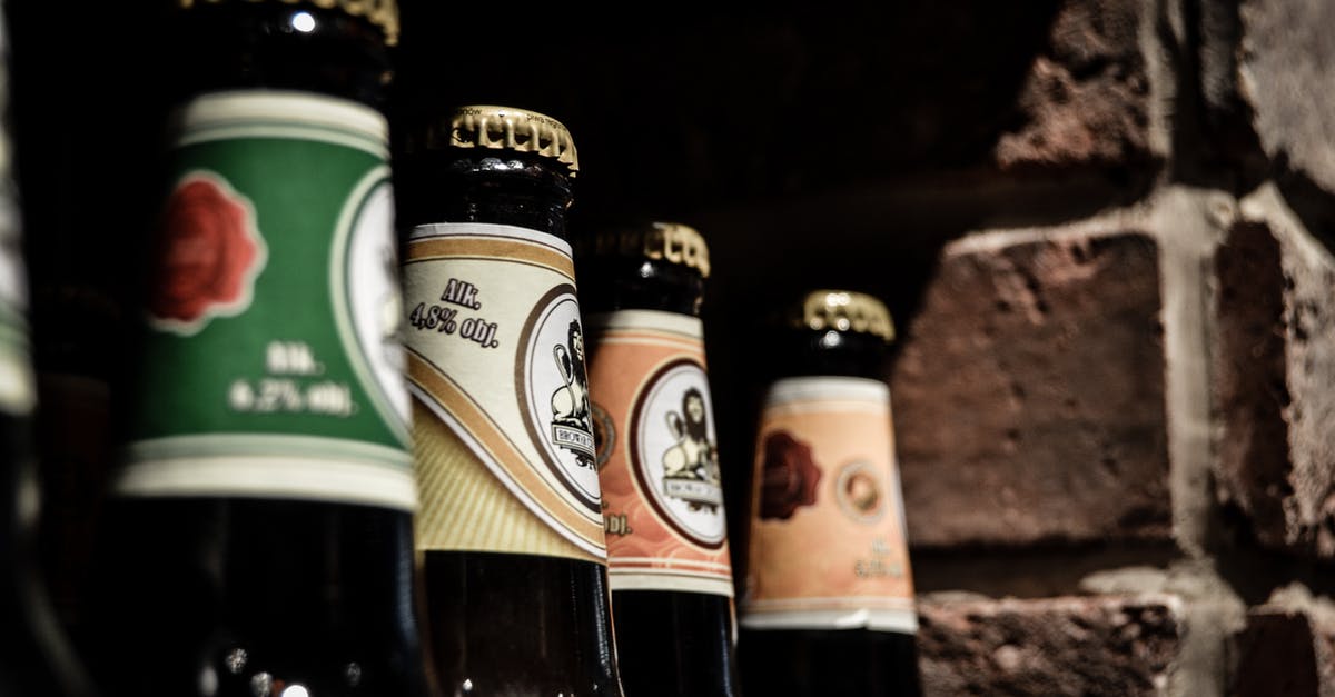 What's different between canned beer and bottled beer? - Green White Labeled Bottle Near Brown White Labeled Bottle