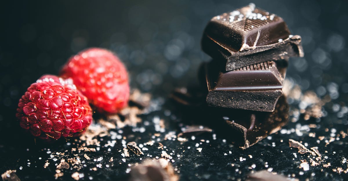 What's Fruit Salt? - Close-Up Photo Of Stacked Chocolates Bars Beside Raspberries