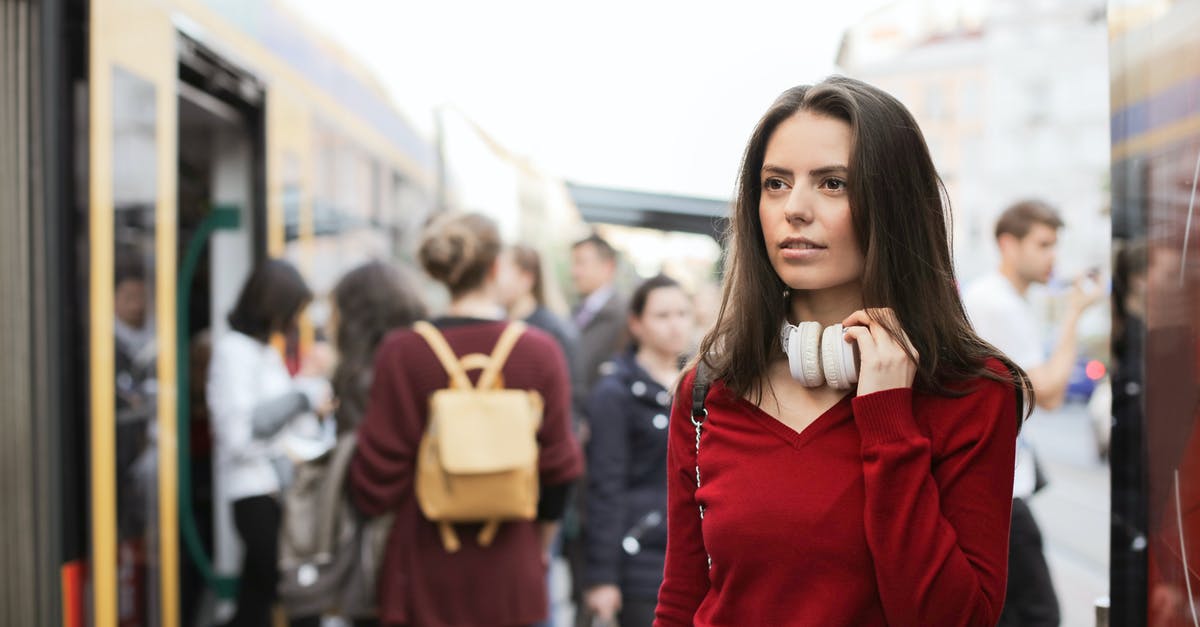 What's the best way to strain stock? - Young woman standing on train platform