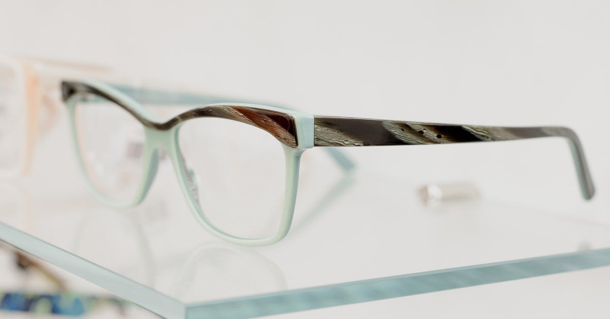 What's the correct way to store fats? - Modern glasses on transparent shelf in optical shop with various lenses and rims