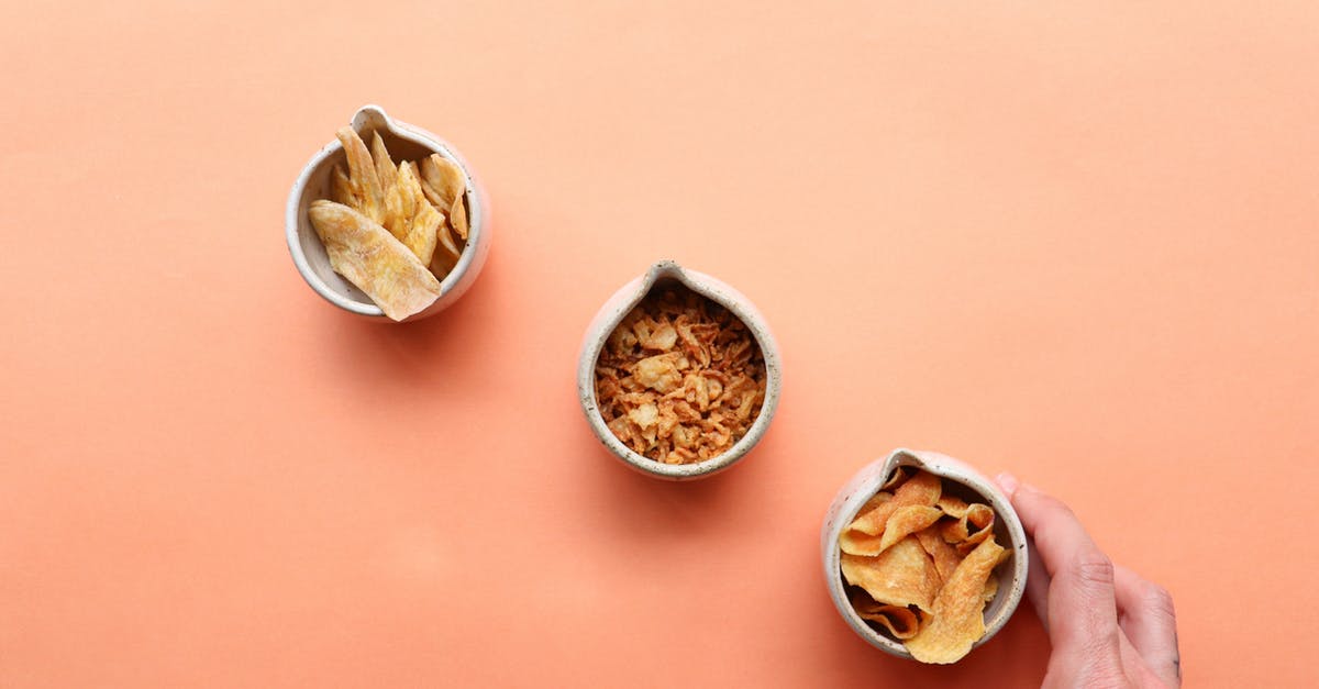 What's the difference between a cobbler, crisp, crumble, buckle, and betty? - Man taking bowl of chips placed near dried fruits