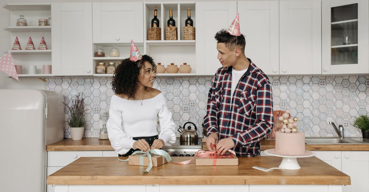 What's the difference between a French oven and a Dutch oven? - Woman in Red and Black Plaid Dress Shirt Standing in Front of Kitchen Sink