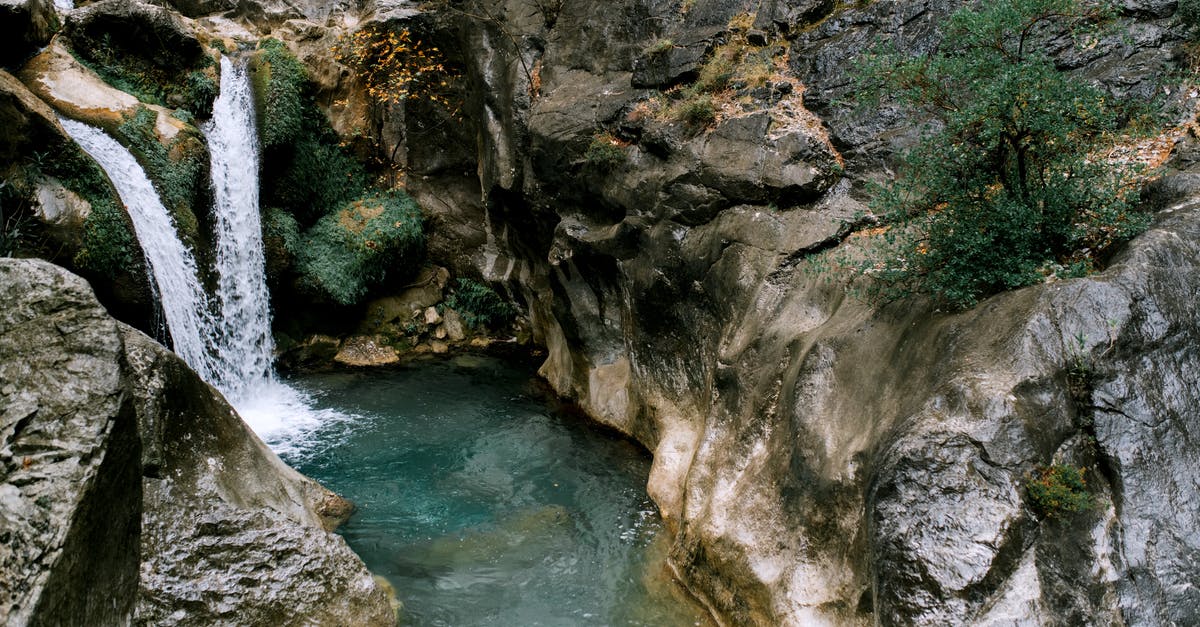 What's the difference between jerky and biltong - Picturesque scenery of high waterfall falling in water stream between  rocky mountains