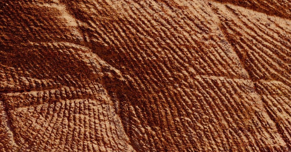 What's the Effect of Browning Butter - Closeup of abstract rough textured parget surface of brown color with cracks