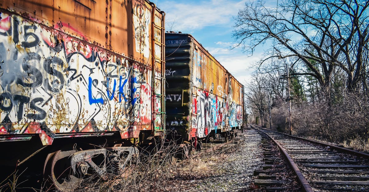 What's the proper way to dispose of used fats & oils? - Old railway carriages with graffiti on surface under cloudy sky