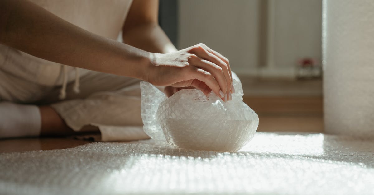 What's the trick to wrapping tightly in plastic wrap? - Person Holding White Plastic Bag