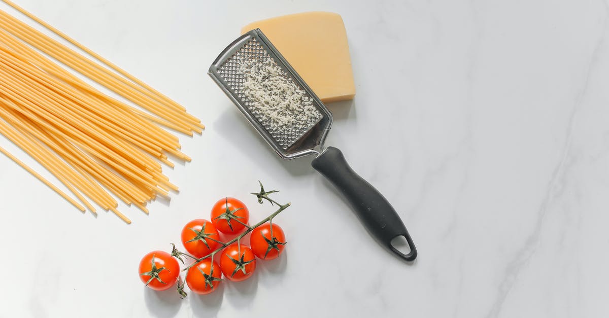 What's this "pucker" style hole on my cheese grater for? - Cheese with Grater Beside Spaghetti and Tomatoes