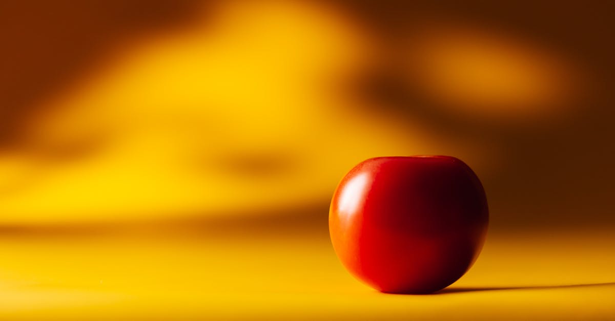 What's this yellow plum-like fruit with a spiky stone? West Africa - Red Cherry Tomato on Yellow Surface