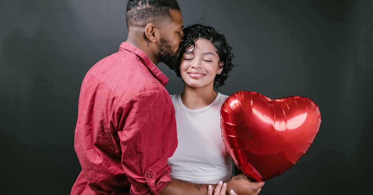 What's wrong with my oven? - Man Kissing His Woman While Holding a Red Heart Shaped Balloon