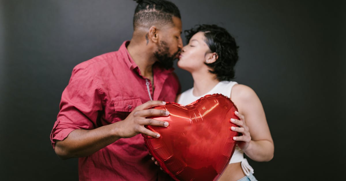 What's wrong with my oven? - Couple Kissing While Holding a Red Heart Shaped Balloon