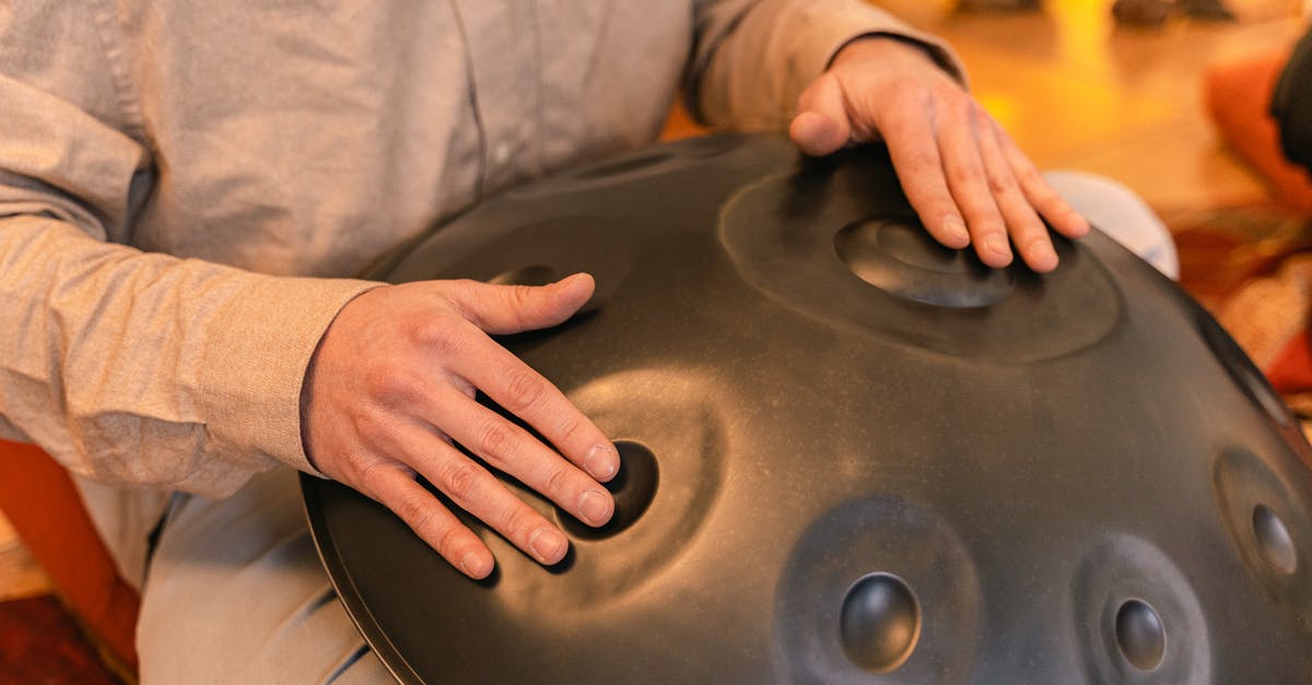 What are alternate uses for leftover buttermilk? [closed] - Close-Up Shot of a Person Using a Handpan