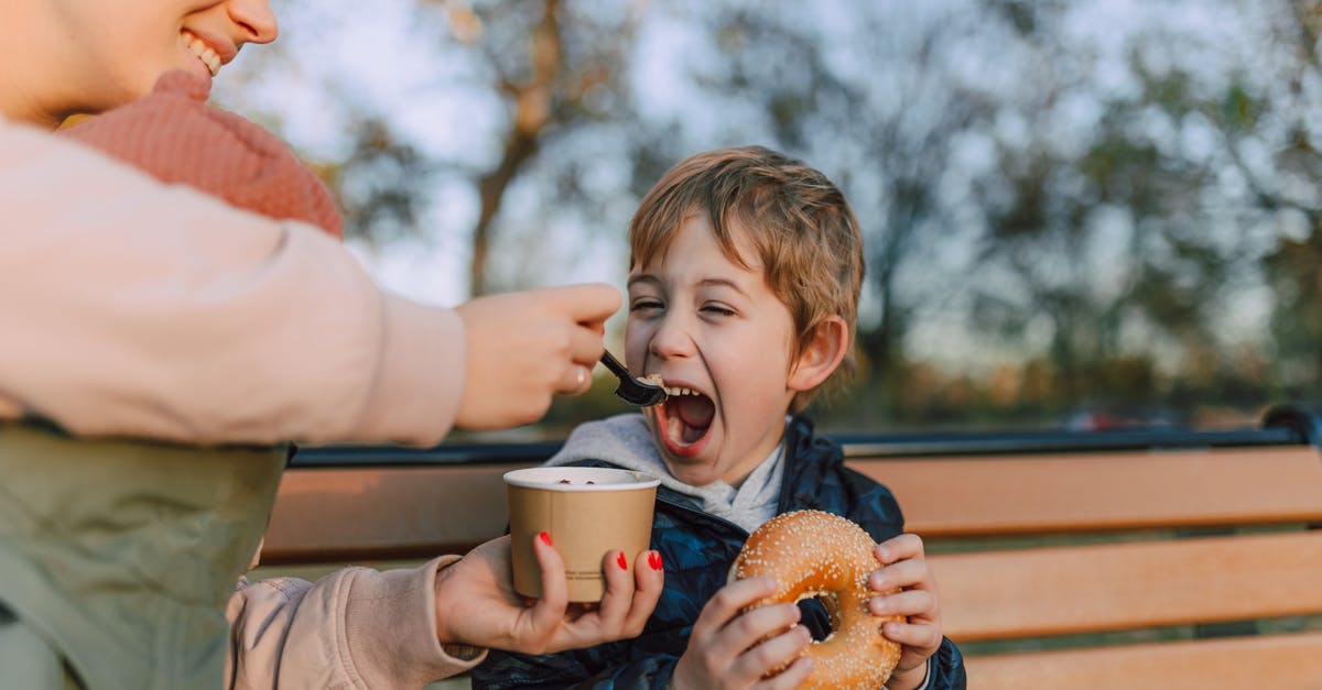 What are bagel chips? - Woman Feeding Kid a Bowl of Ice Cream