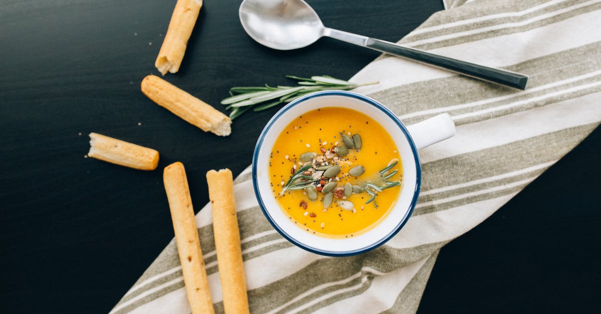 What are good ingredients to put into a Scrapple soup stock? - White Ceramic Bowl with Yellow Soup