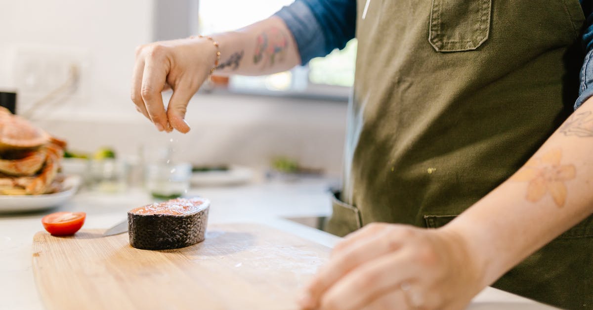 What are some interesting herbs/spices to sprinkle over fish? [closed] - Unrecognizable Female Hand Sprinkling Salt on Fish Slice