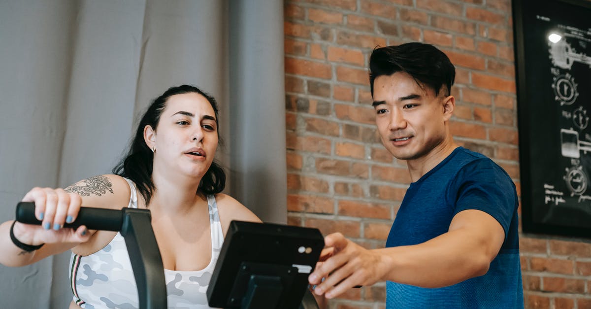 What are some low fat butter substitutes for cookies? - Young Asian male trainer checking fitness equipment while instructing overweight female