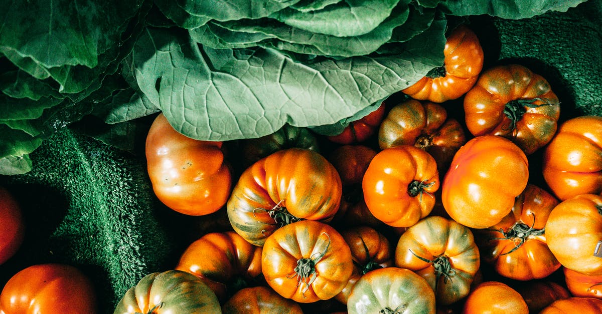 What are the 'acidity controllers' used in canned whole tomatoes? - Top view composition of ripe green cabbage leaves and organic tomatoes heaped together on vegetable market stall