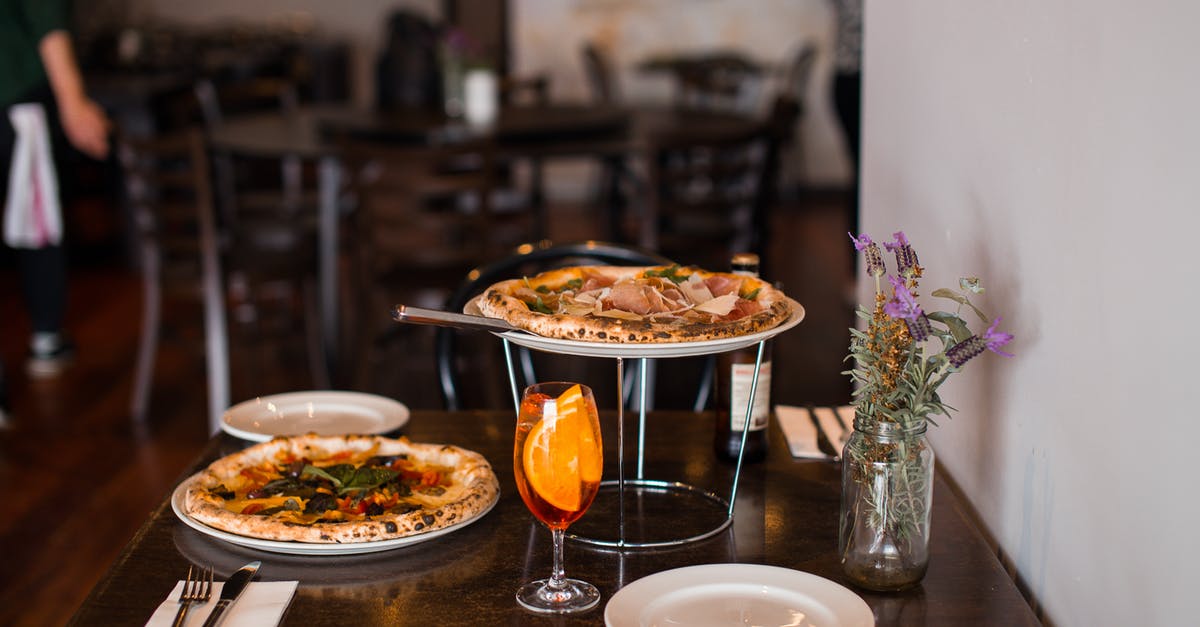 What are the impacts of a worn pizza stone? - White Ceramic Plate With Food on Brown Wooden Table