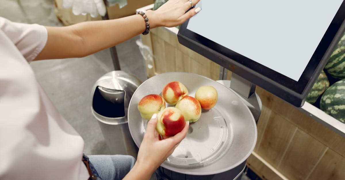 What are the risks to store a digital scale under an object? - From above of unrecognizable woman touching screen of electronic scales and putting peaches while weighing peaches on scales in contemporary supermarket