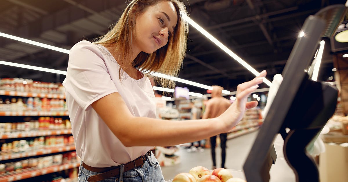 What are the risks to store a digital scale under an object? - Side view of young woman in trendy clothes weighing peaches on scales while  shopping in supermarket during purchase food