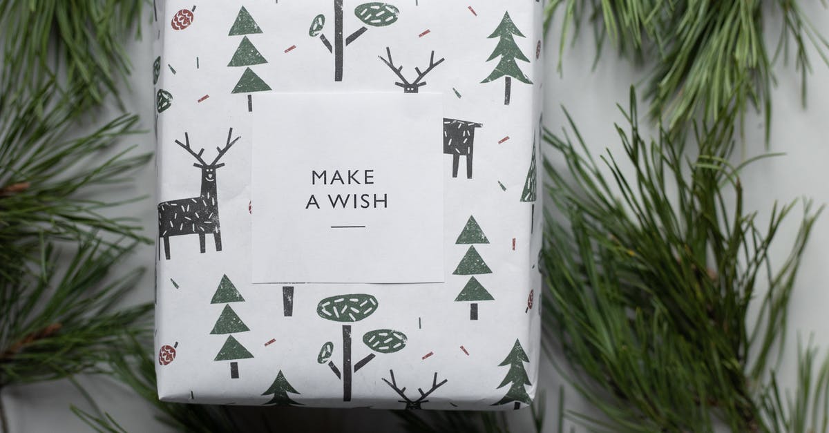 What are the safety considerations in making pine needle tea? - Wrapped New Year present box placed among coniferous branches