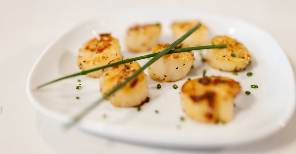 What are the tasteful herbs served with dizi in Iran? - Fried Scallops with Herbs Served on White Plate