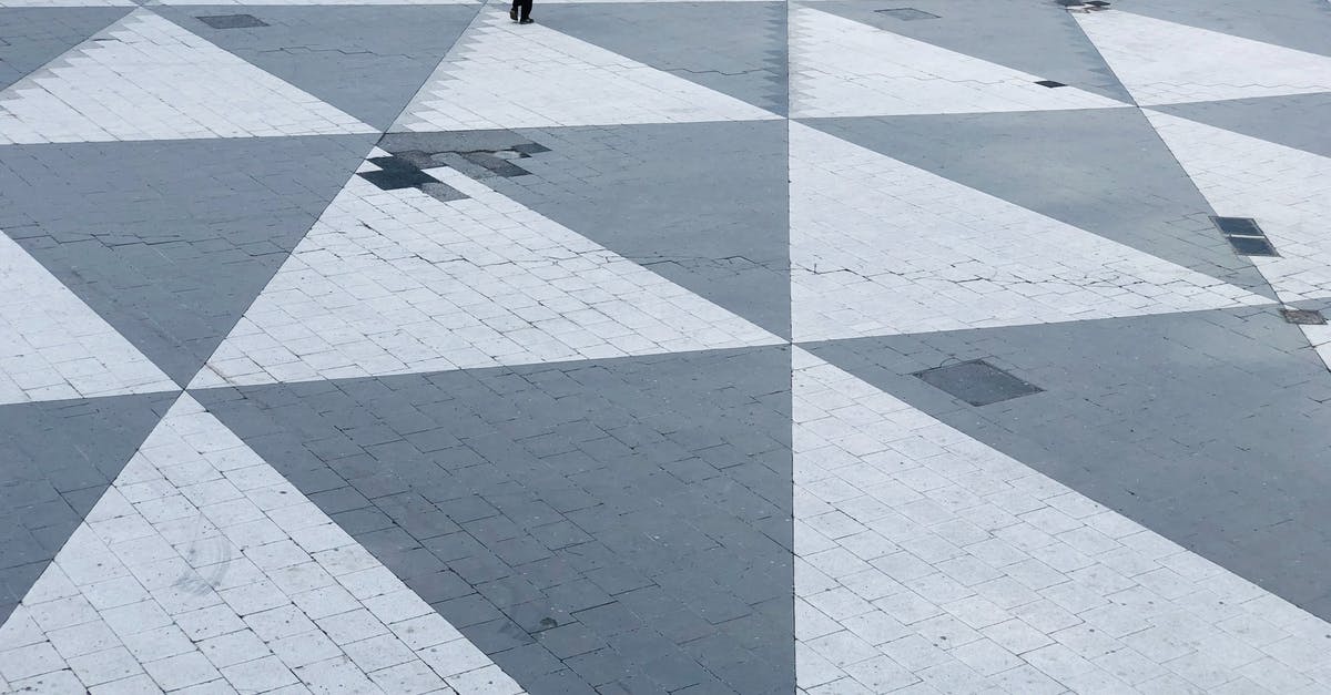 What are the triangular shaped markings on asparagus called? - A Person Walking the Pedestrian Plaza of Sergels Torg in Norrmalm, Stockholms, Sweden