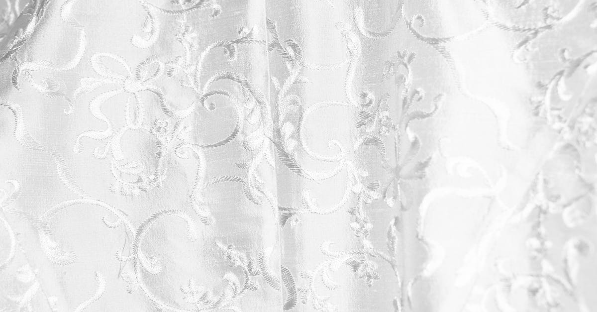 What are these white and thick things in my egg? - Background of white curtain with bright thick textile and creative design with ornamental elements creating swirls hanging in light room