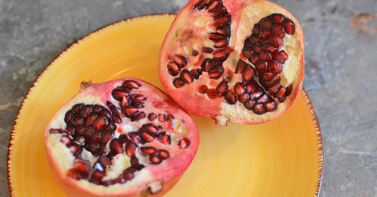 What are ways to extract the juice from a pomegranate? - Ripe pomegranate on yellow plate