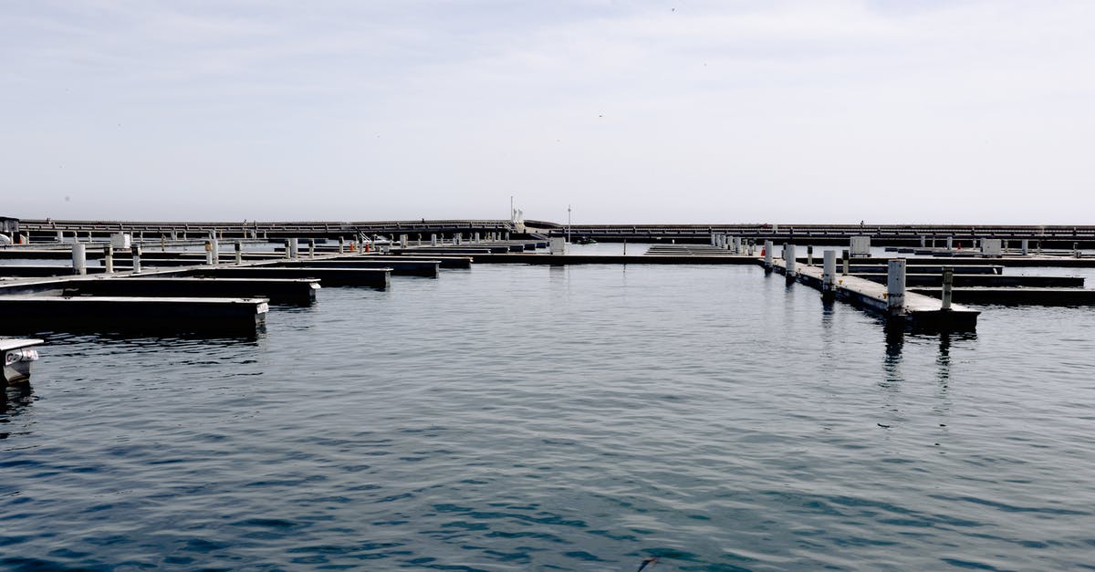 What can I do with a lot of bay leaves? - Sea water with empty lots for yachts and boats parking in harbor against cloudy sky