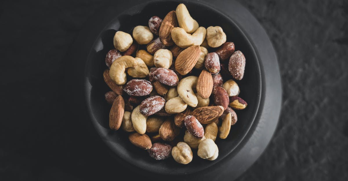 What can I do with Hazelnuts and Walnuts? [closed] - Flatlay of Assorted Nuts on Black Bowl