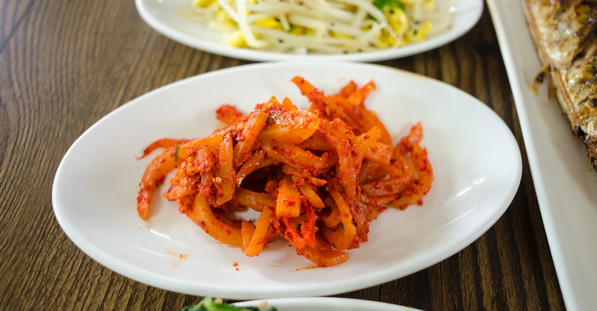 What can I substitute for radish when making kimchi? - Ceramic Plates with Side Dishes on a Wooden Surface