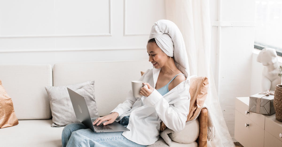 What can I use instead of a tea towel? - A Woman in a Head Towel Using her Laptop While Sitting on a Couch
