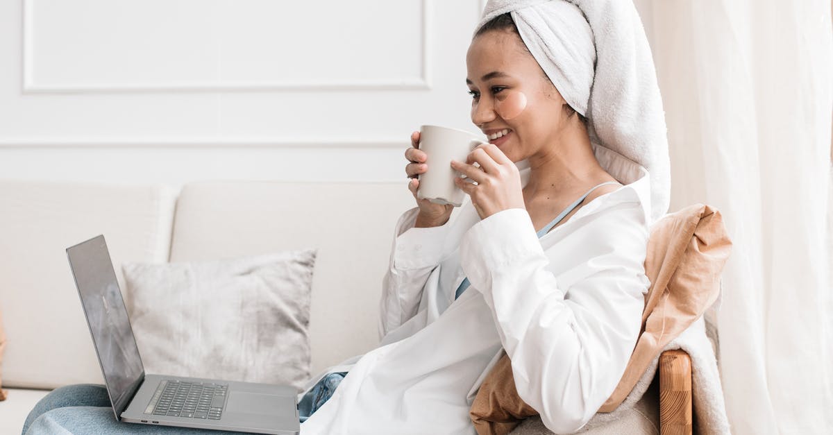What can I use instead of a tea towel? - A Woman Looking at a Laptop While Holding a Mug