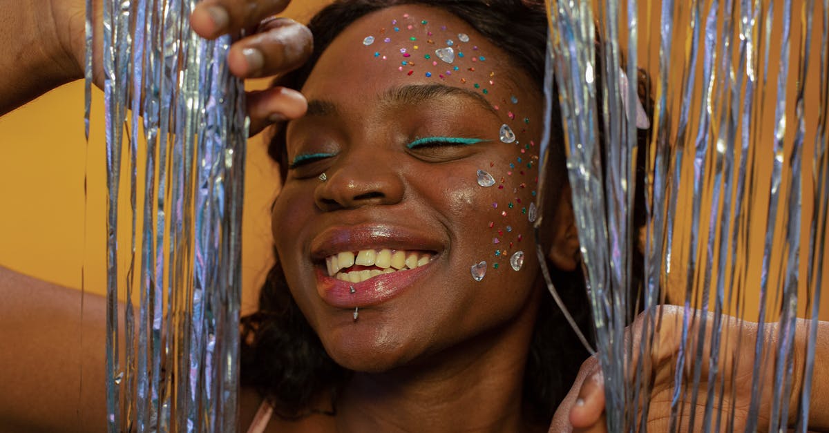 What causes odd off-flavor/smell in tofu? - Happy black woman with makeup and sequins on face