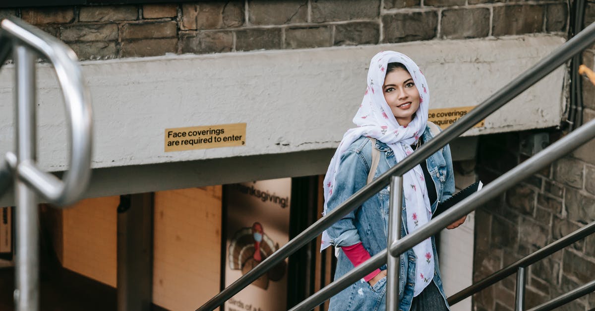 What causes popovers to rise so much? - Charismatic woman in casual wear and headscarf with notebook in hand rising on stairs from underpass and looking at camera while having walk in city