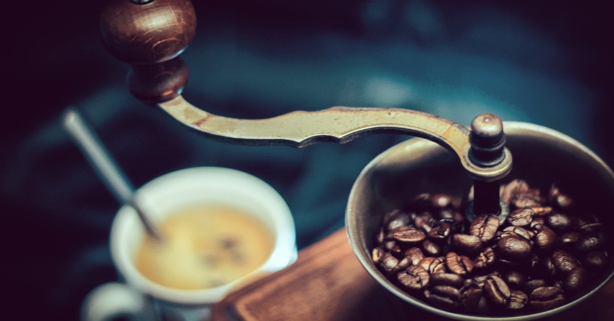 What causes static in a coffee grinder's receptacle? - Selective Focus Photography of Vintage Brown and Gray Coffee Grinder