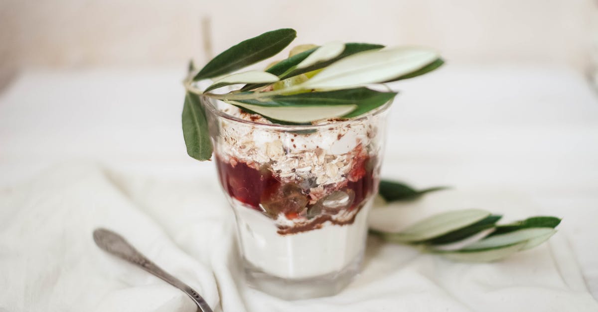 What causes yogurt in sauces to split? How to prevent it? - Delicious dessert in glass with olive leaves