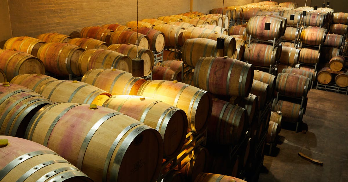 What defines the type of the fermentation (alcohol/lacto)? - Photograph of a Room Filled with Barrels