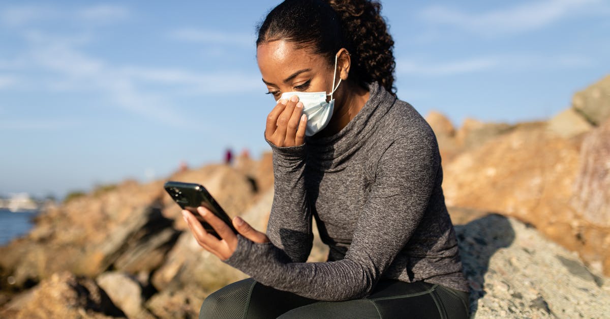 What difference would using Rock Sugar make in tea? - A Woman in a Face Mask Using her Cellphone while Sitting on a Rock