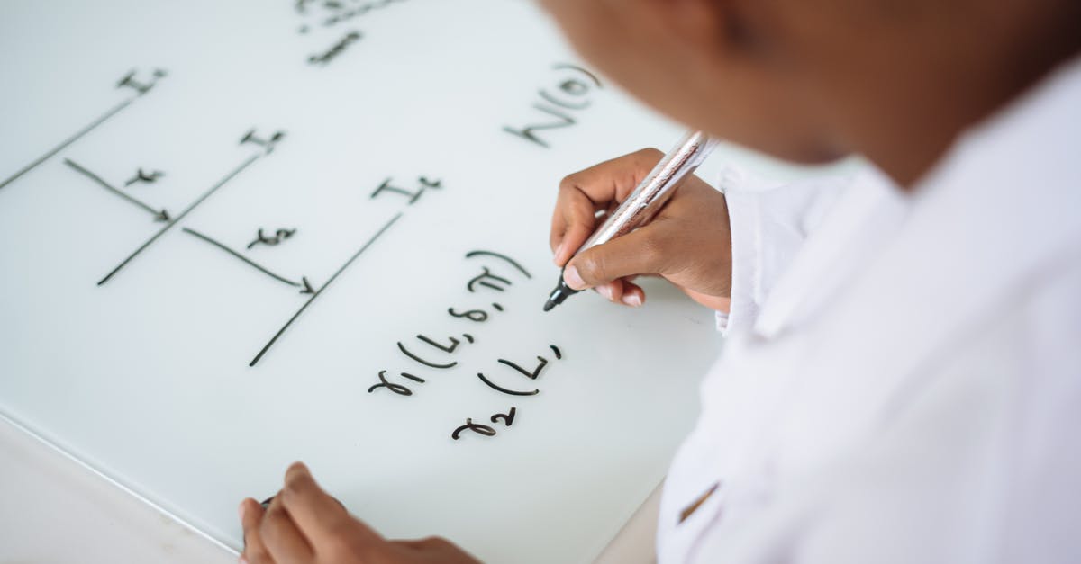 What do the numbers used to differentiate Chinese slicer knives mean? - From above anonymous ethnic student wearing uniform and solving problem in chemistry while writing formula on white table in lab