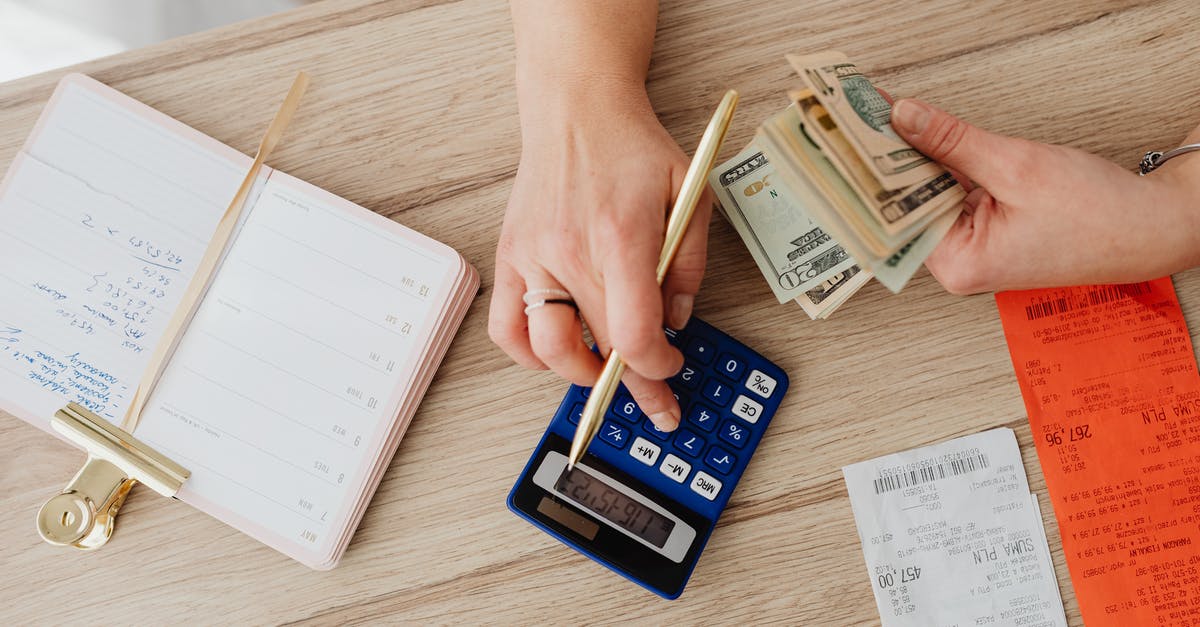 What do the numbers used to differentiate Chinese slicer knives mean? - Person Holding Paper Bills while Using a Calculator