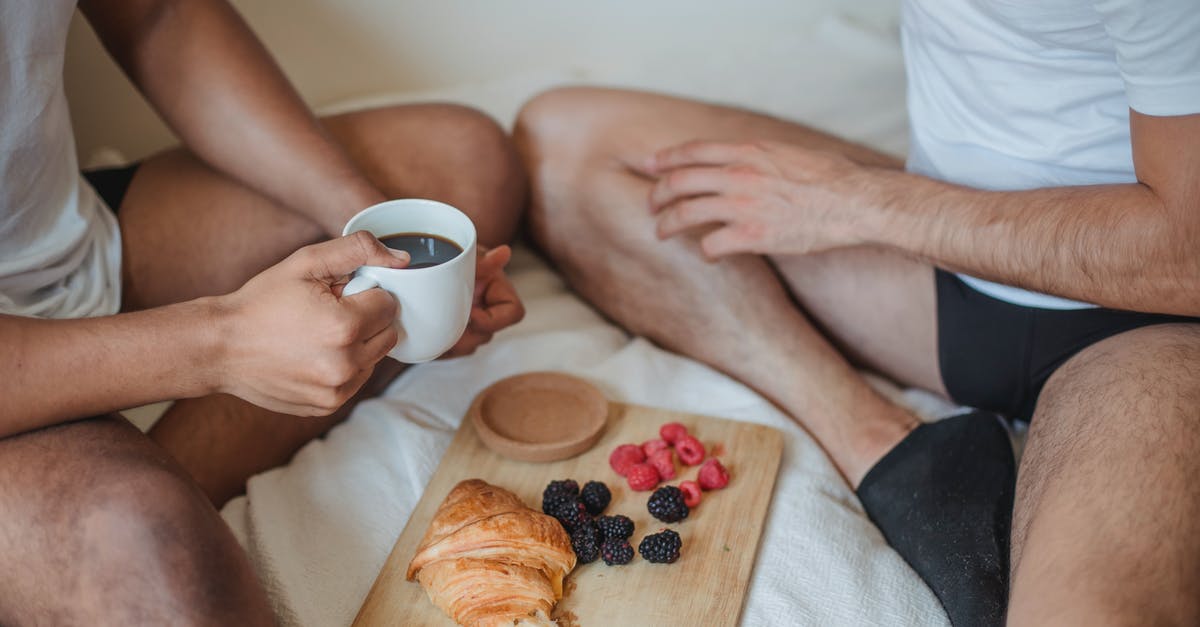 What do you have for breakfast during camping [closed] - Two Unrecognizable Men Sitting on Bed and Having Breakfast