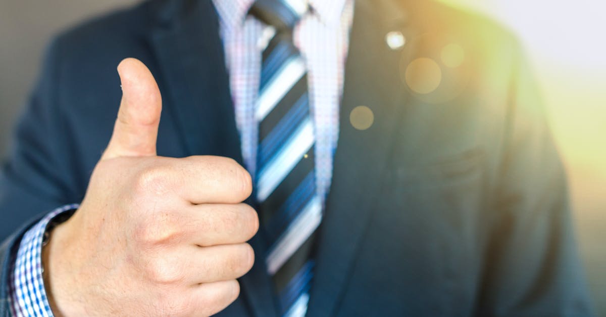 What does 100 grams of something look like? [closed] - Close-up Photo of Man Wearing Black Suit Jacket Doing Thumbs Up Gesture