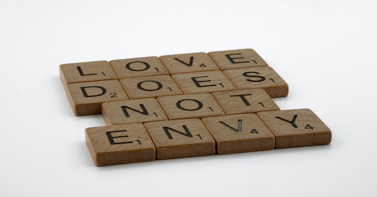 What does "cooking bacon" mean? - Close-Up Shot of Scrabble Tiles on a White Surface