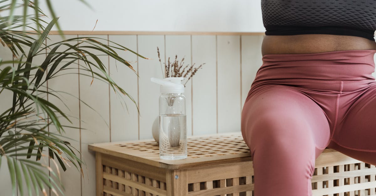 What does resting mean - Woman in Black Tank Top and Red Skirt Sitting on Brown Wooden Chair