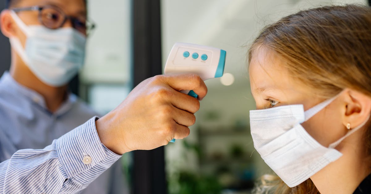 What does the "operating range" of a thermometer mean? - Girl in White and Blue Stripe Long Sleeve Shirt Holding White Smartphone