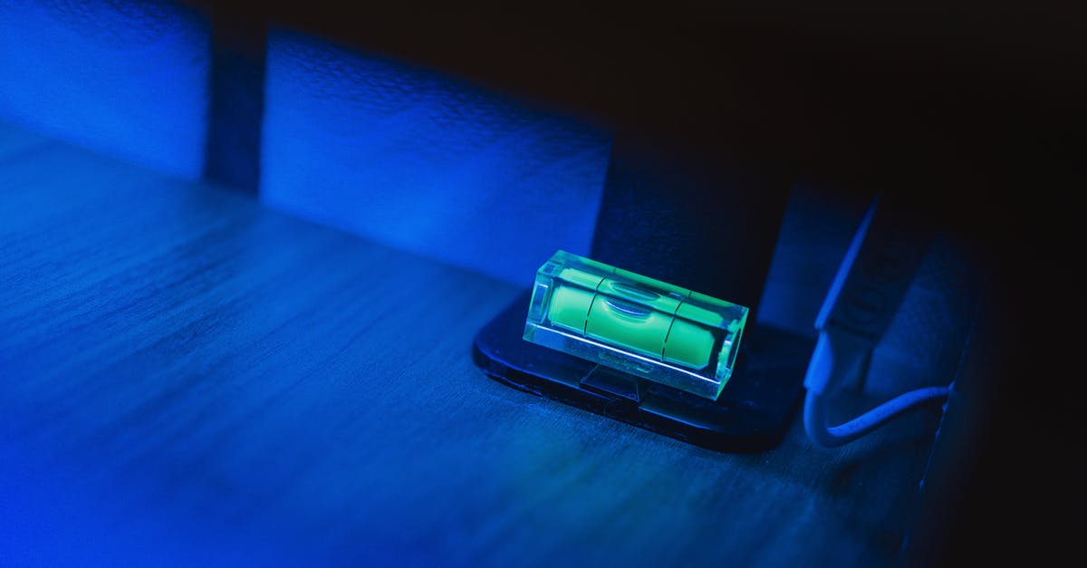 What exactly is a chowder? - Small illuminating green neon bubble level placed on monitor stand in dark room