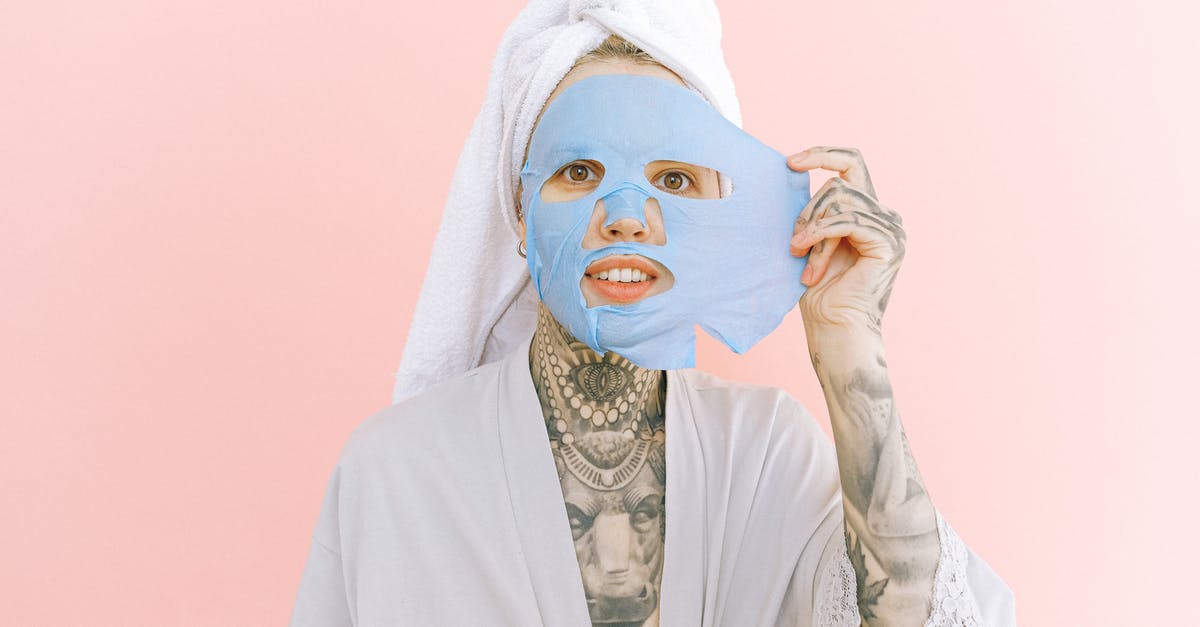 What exactly is this residue and how do I clean it off? - Woman with tattoos removing collagen mask from face