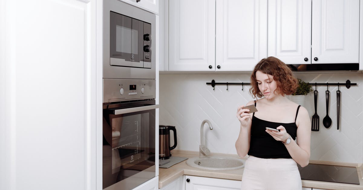 What factors should I consider when buying kitchen tongs? - Woman Leaning on a Kitchen Counter